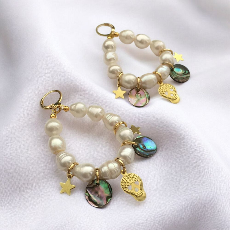 Gold-plated brass earrings featuring a pearl and star design, perfect for adding a touch of elegance to any outfit.