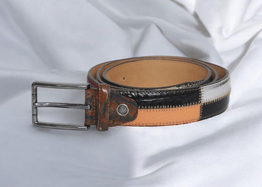 A belt featuring a stylish design with black, white, and orange stripes.