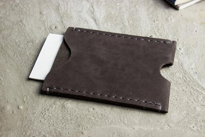 A wallet with a card holder resting on top, showcasing a sleek and organized design for easy access to cards.