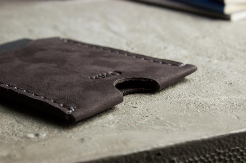 A wallet with a card holder resting on top, showcasing a sleek and organized design for easy access to cards.