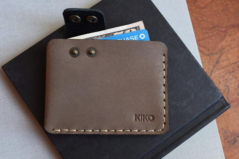  A modern wallet with dual card holders, designed for convenient access and organization of your essential cards.