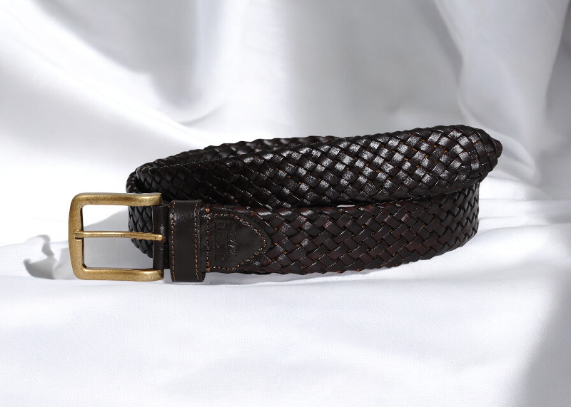 A stylish belt featuring a woven pattern and a shiny gold buckle, perfect for adding flair to any outfit.