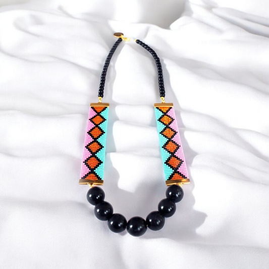 A vibrant necklace featuring an array of colorful beads interspersed with elegant black beads.