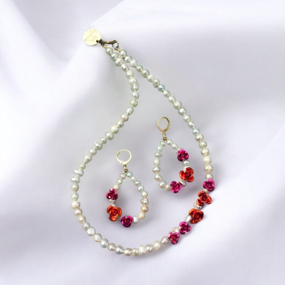 Elegant pearl necklace and earrings set adorned with vibrant red flowers, perfect for adding a touch of sophistication.