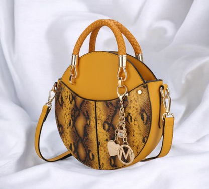 A yellow snake skin bag featuring a stylish chain strap, showcasing a blend of elegance and modern design.

