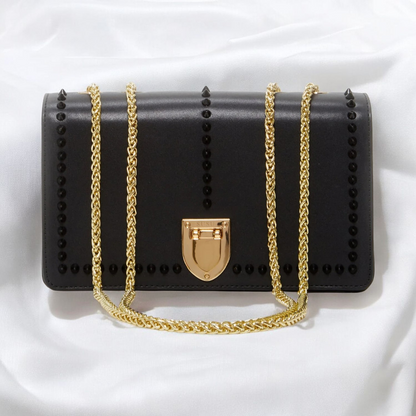 Elegant black leather clutch bag adorned with a luxurious gold chain, perfect for any sophisticated occasion.