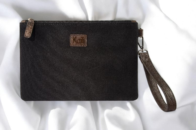  A black canvas wristlet envelope pouch featuring a stylish leather strap for easy carrying and a sleek look.