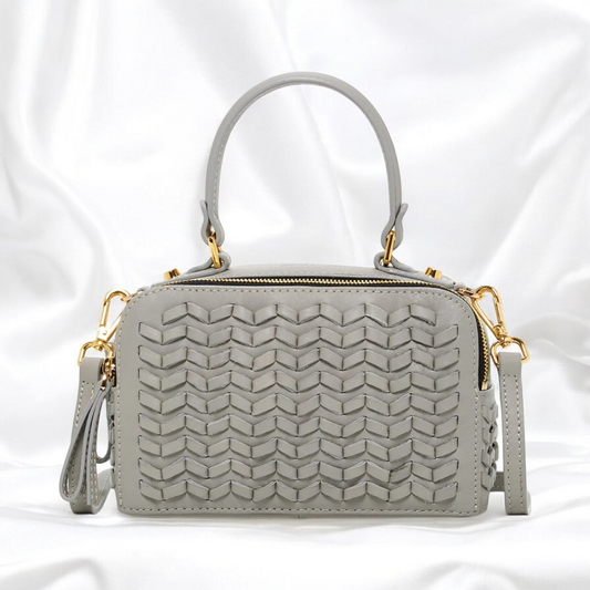 This stylish wicker grey crossover purse will be a standout this season with its gold-polished hardware.