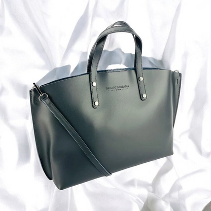 A sophisticated black leather tote bag elegantly displayed, showcasing its luxurious texture and timeless design.