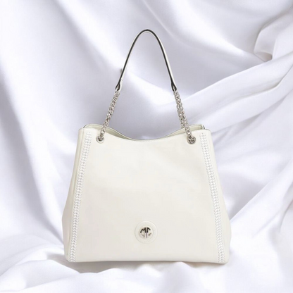  A stylish white handbag featuring elegant chain handles, perfect for any fashionable occasion.