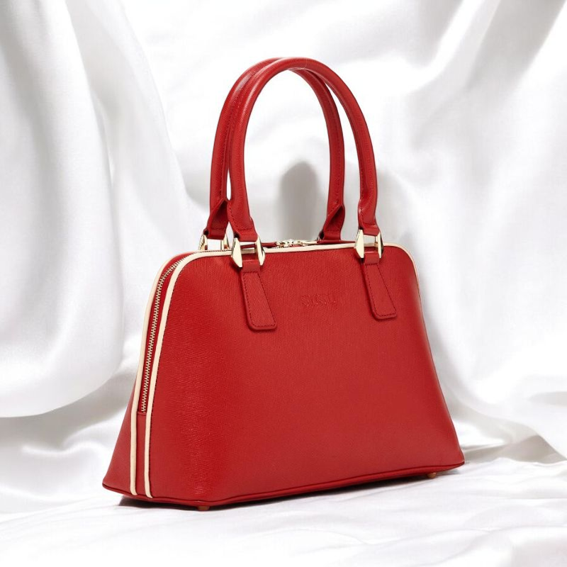 A stylish red handbag featuring a luxurious gold handle, perfect for adding elegance to any outfit.