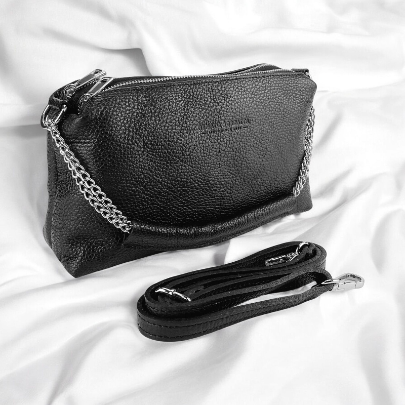 Elegant black purse featuring a chic chain and strap, perfect for adding a touch of sophistication to any ensemble.