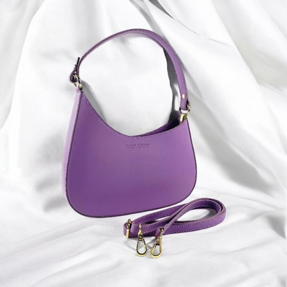  Exquisite purple leather bag with a chic strap and refined handle, embodying elegance and style for the discerning individual.