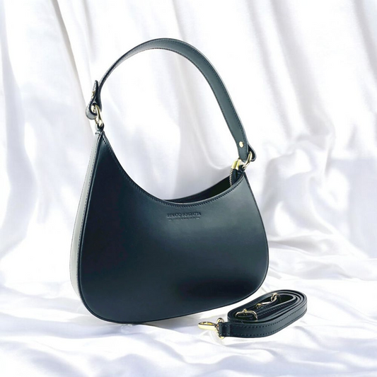 A black leather bag featuring a stylish gold chain, showcasing elegance and sophistication in its design.