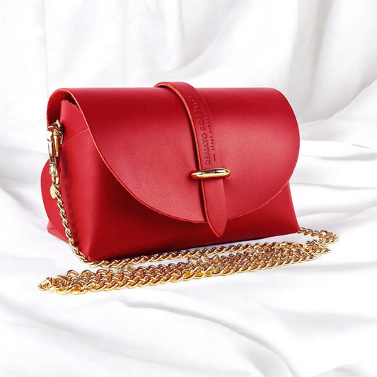 A red leather crossbody bag featuring a stylish gold chain for an elegant touch.