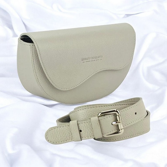  An exquisite grey leather belt bag affixed to a purse, highlighting a harmonious fusion of luxury and practicality.