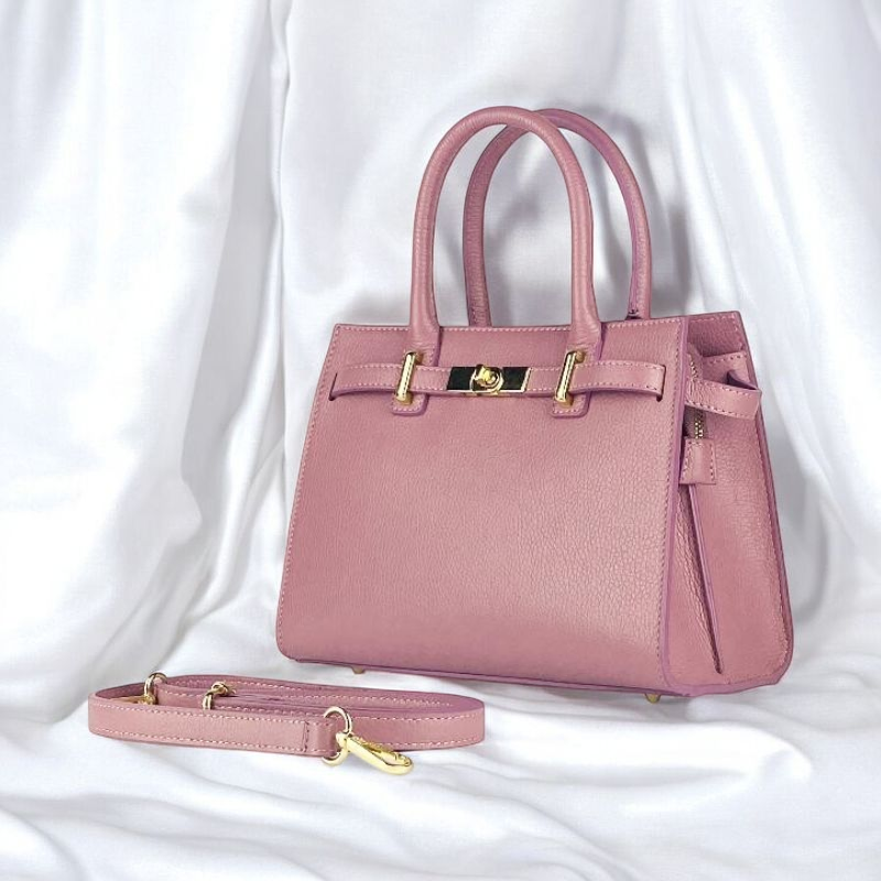 Elegant pink calfskin handbag, showcasing luxurious leather craftsmanship and a chic design for the discerning fashionista.