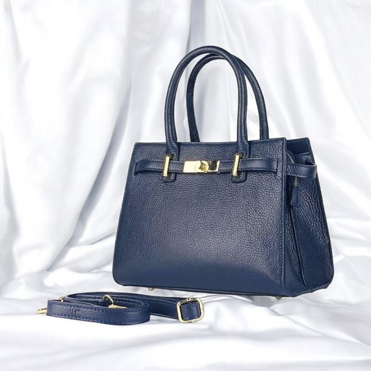 A blue leather handbag featuring elegant gold hardware, showcasing a stylish and sophisticated design.
