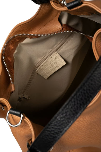 A close-up of a cognac leather handbag showcasing exquisite interior craftsmanship and attention to detail.