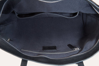 An interior shot of a black bag, highlighting its zippers and spacious compartments for easy access to belongings.