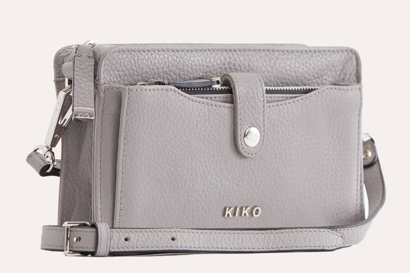  A sleek grey leather crossbody bag, compact and trendy, ideal for carrying essentials while on the go.
