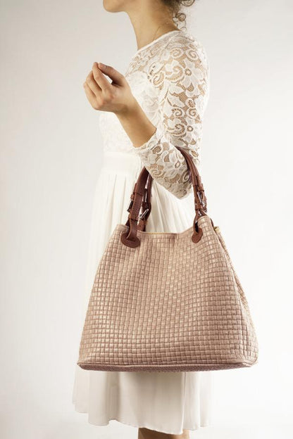 woman with white dress carry a taupe colored woven handbag