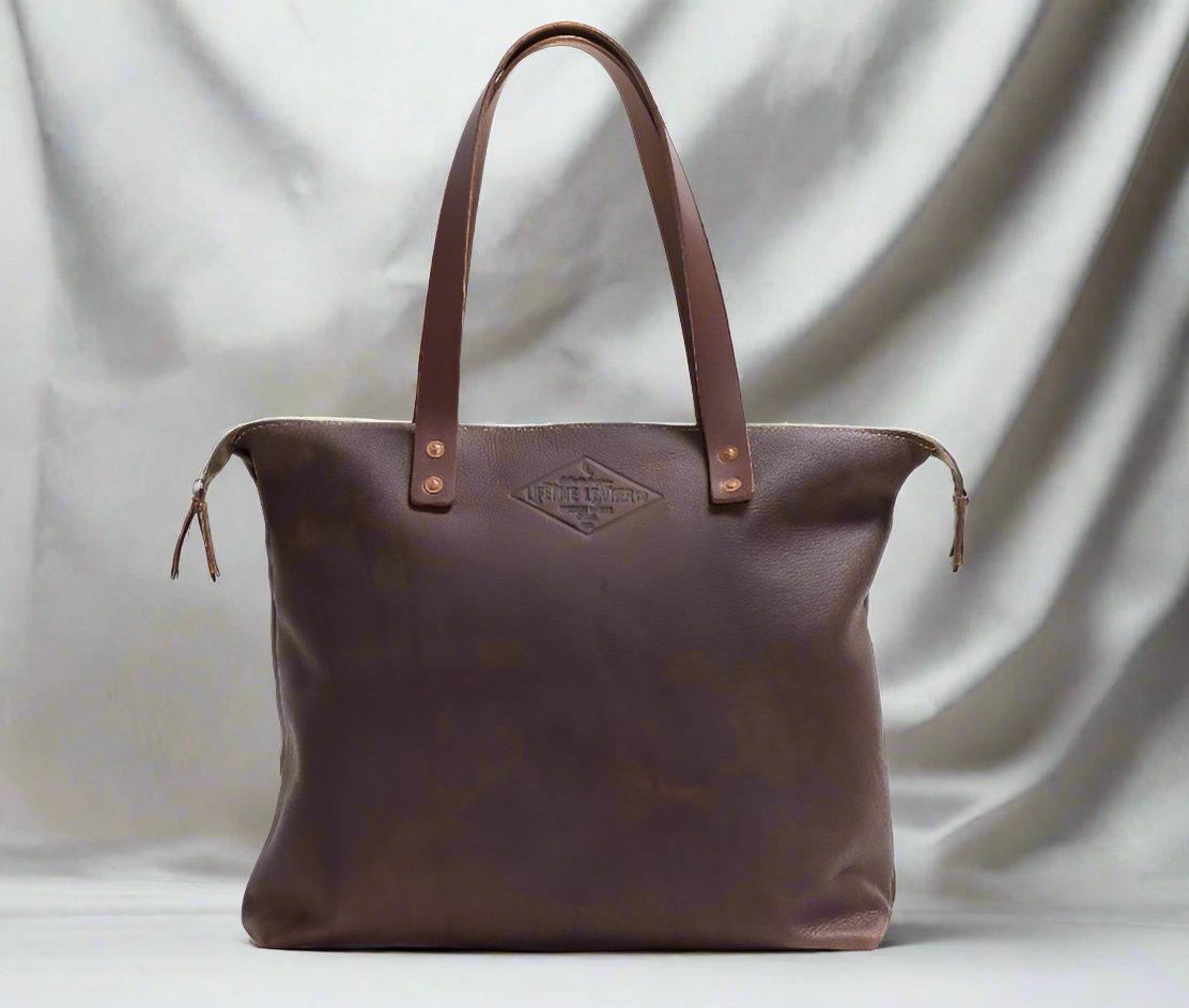 Elegant brown leather tote bag featuring a chic tassel on the handle, perfect for sophisticated outings.