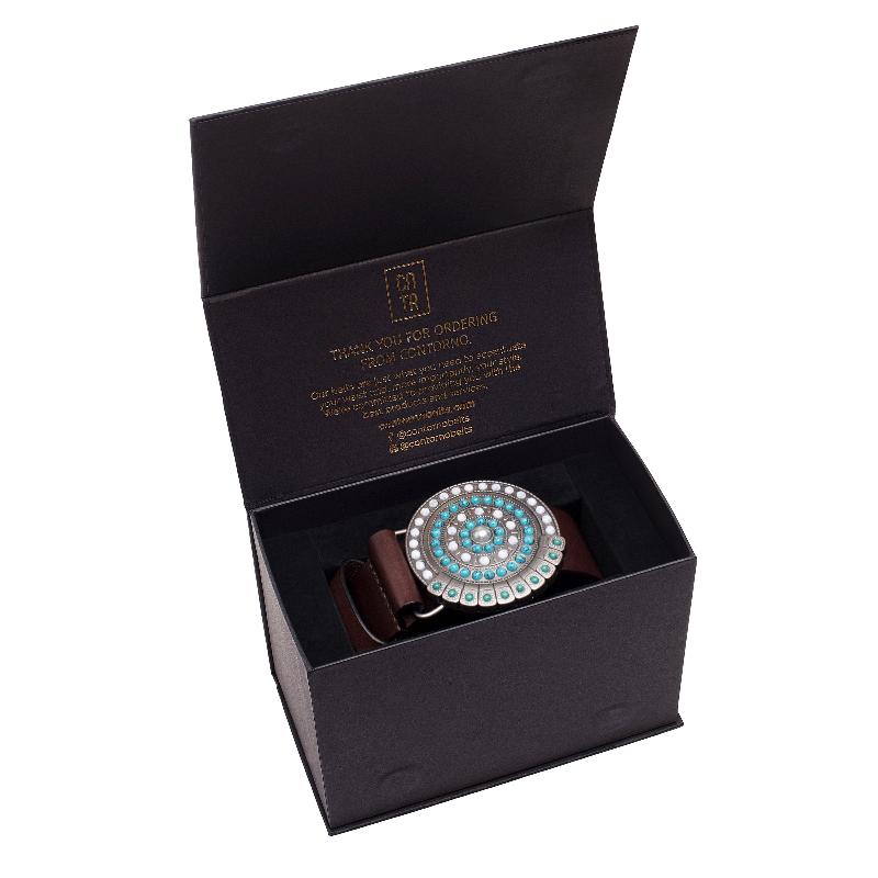  A stylish belt displayed in a sleek black box featuring a vibrant turquoise and blue design.