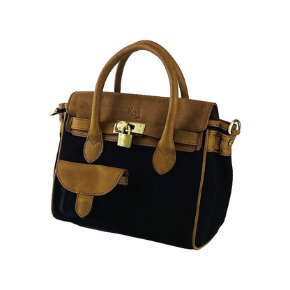 A sophisticated black and tan handbag featuring a stylish strap, perfect for elevating any ensemble with elegance.