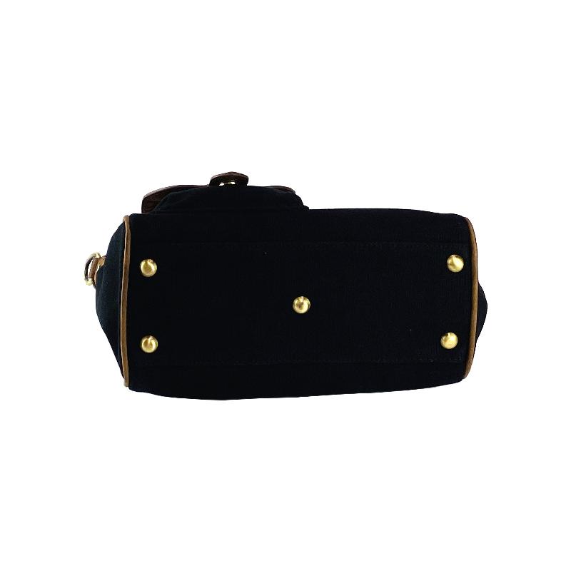 A sophisticated black and tan handbag featuring a stylish strap, perfect for elevating any ensemble with elegance.