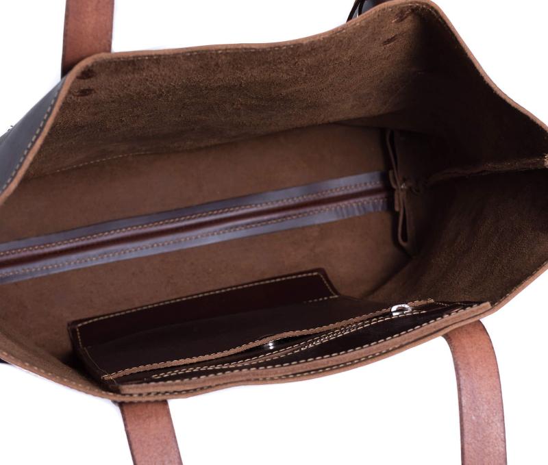 A luxurious brown leather bag interior showcasing a sleek zipper and rich texture, exuding elegance and sophistication.