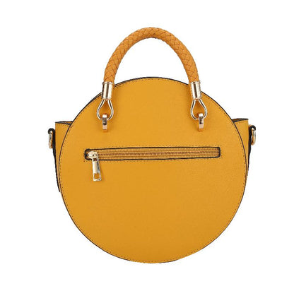 A yellow vegan leather bag featuring a stylish chain strap, showcasing a blend of elegance and modern design.
