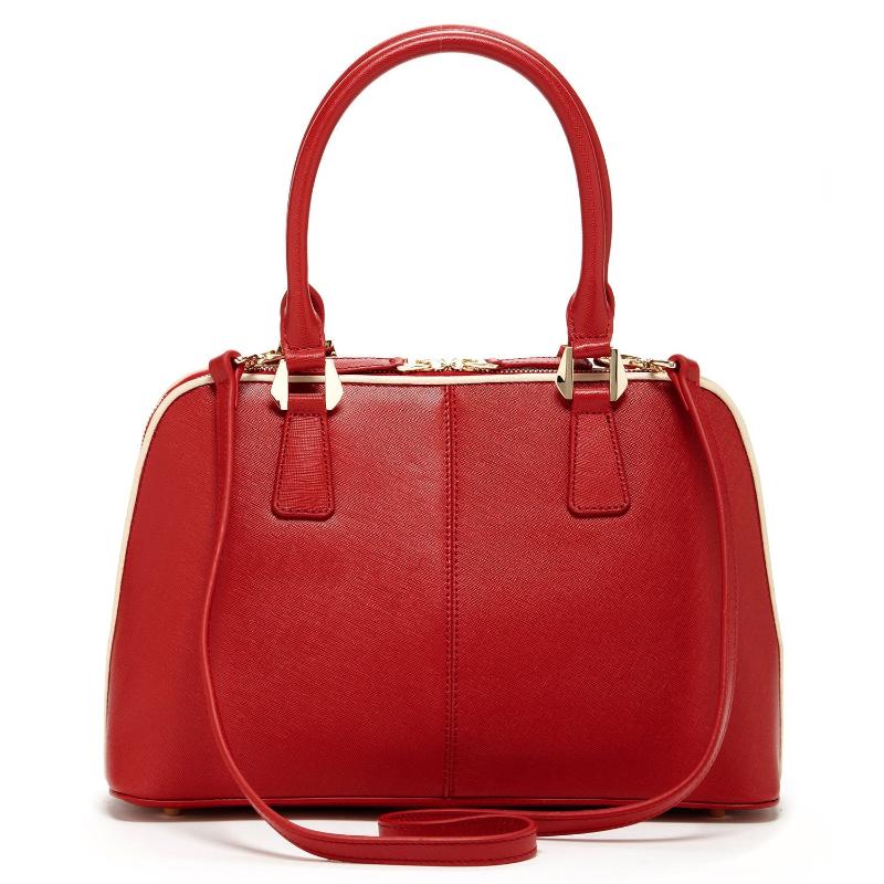 A stylish red handbag featuring a luxurious gold handle, perfect for adding elegance to any outfit.