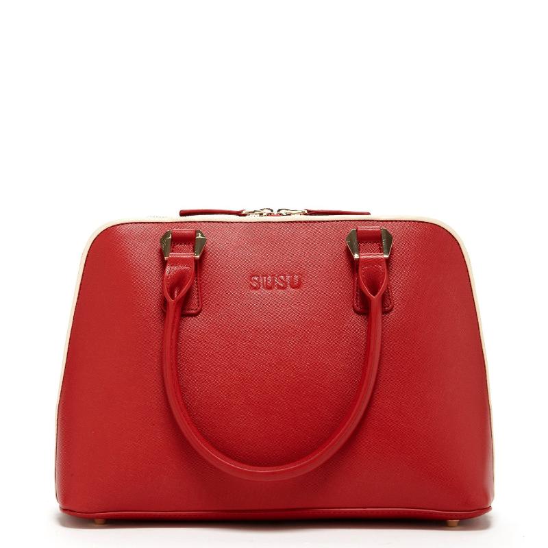 A stylish red handbag featuring a luxurious gold handle, perfect for adding elegance to any outfit.