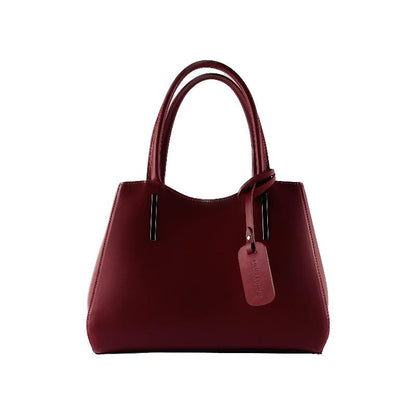 A luxurious burgundy leather handbag elegantly displayed against a pristine white background, showcasing its exquisite craftsmanship.