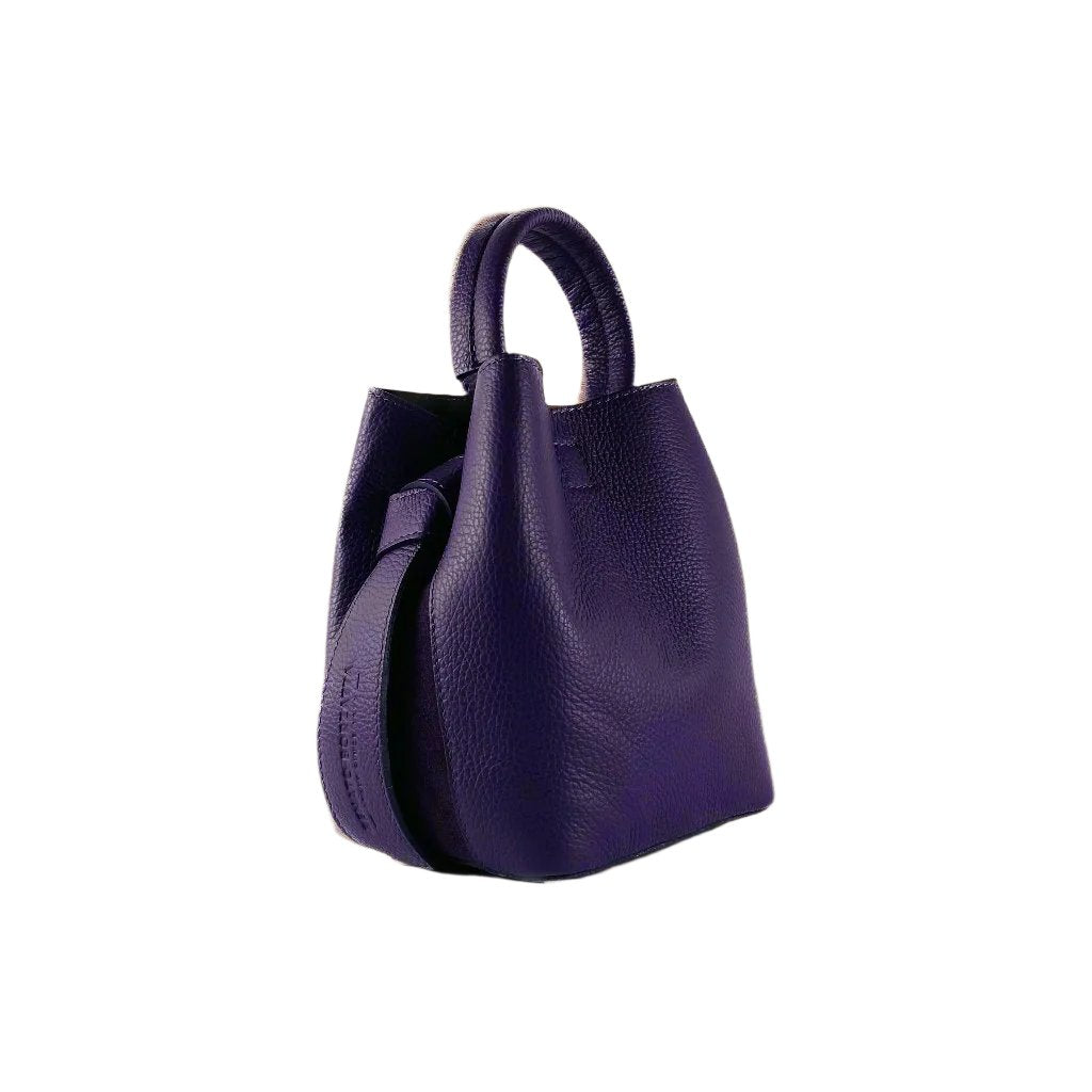 Elegant purple leather handbag featuring a chic strap, perfect for adding a touch of luxury to any ensemble.