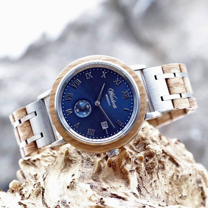 A wooden watch featuring a blue dial and a silver bracelet, showcasing a blend of natural and modern design elements.