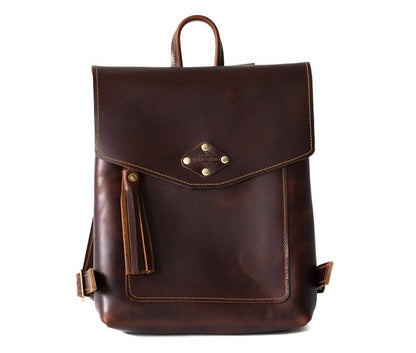 Stylish brown leather backpack featuring decorative tassels and studs, perfect for adding flair to any outfit.