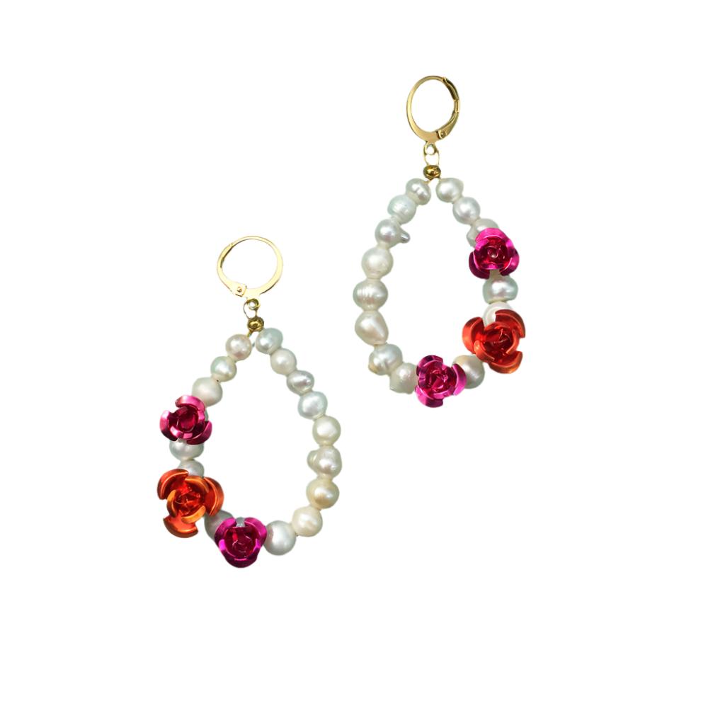 Elegant earrings featuring white pearls adorned with vibrant red flowers, perfect for adding a touch of sophistication.