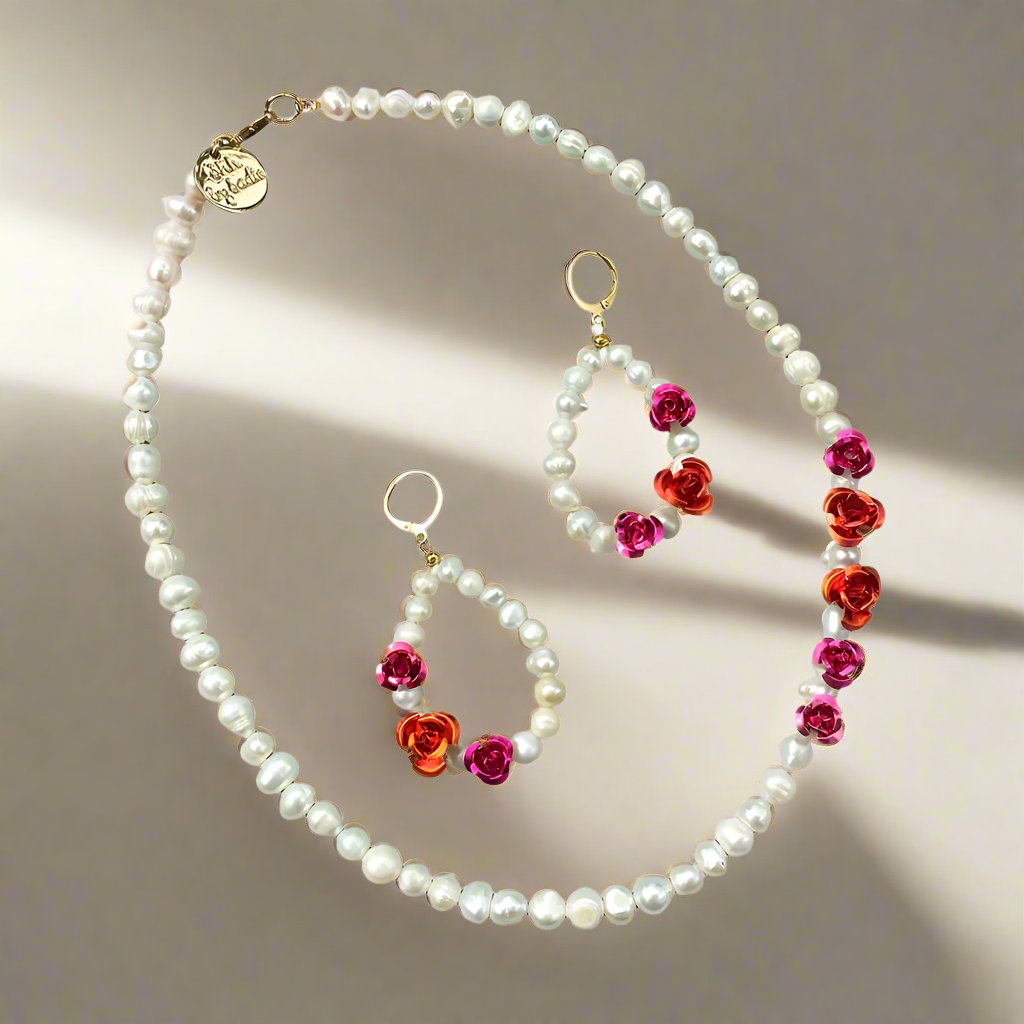 Elegant pearl necklace and earrings set adorned with vibrant red flowers, perfect for adding a touch of sophistication.