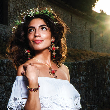 A woman in a flowing white dress highlights her beautiful earrings, creating a striking and elegant appearance.