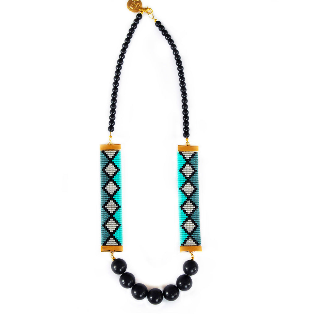 Elegant necklace featuring a stunning arrangement of black beads interspersed with vibrant green and luxurious gold accents.