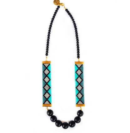 Elegant necklace featuring a stunning arrangement of black beads interspersed with vibrant green and luxurious gold accents.