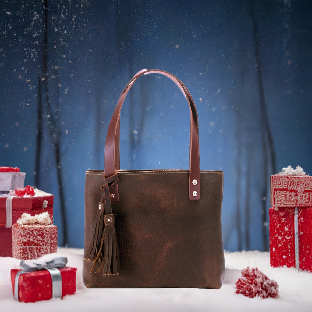 A luxurious brown leather tote bag adorned with a stylish tassel, exuding elegance and sophistication.