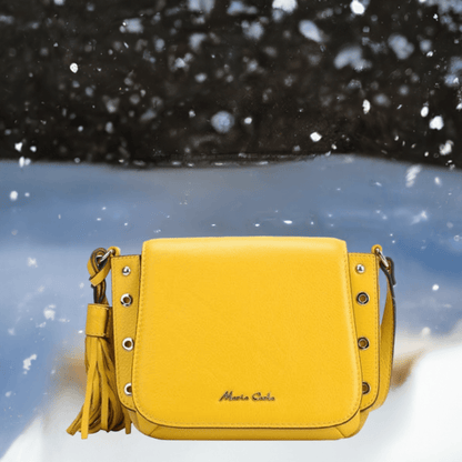 A yellow leather crossbody bag featuring stylish tassels, perfect for adding a pop of color to any outfit.