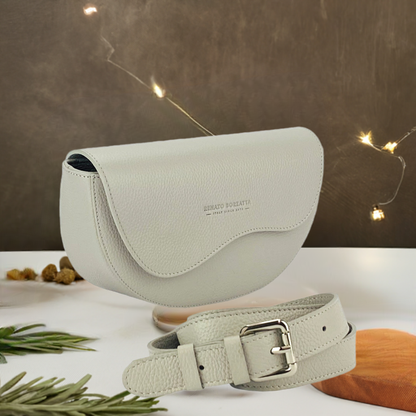  An exquisite grey leather belt bag affixed to a purse, highlighting a harmonious fusion of luxury and practicality.