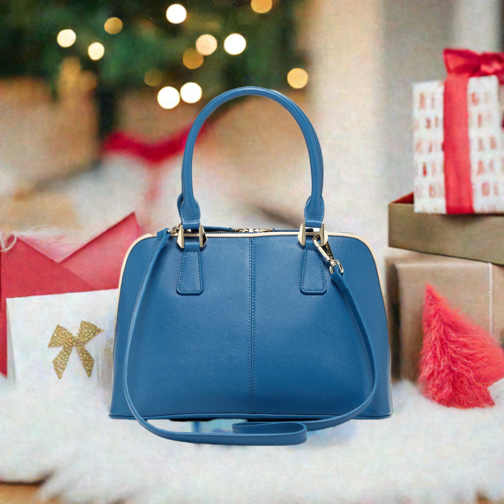 A chic blue handbag elegantly rests on a pristine white cloth, showcasing its vibrant hue against the soft backdrop.