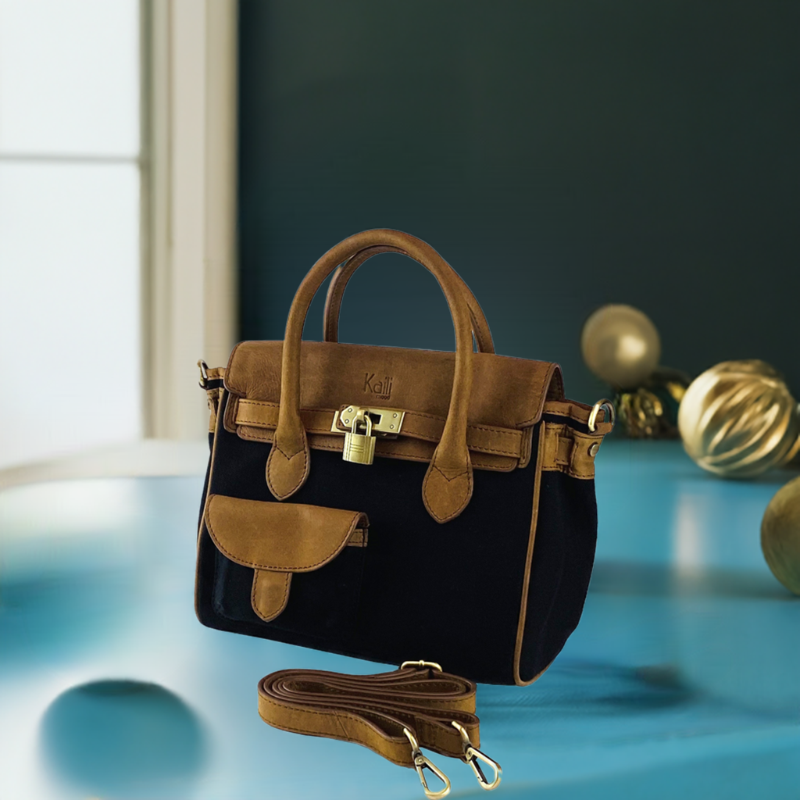 A sophisticated black and tan handbag featuring a stylish strap, perfect for elevating any ensemble with elegance.