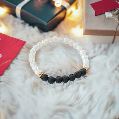 Black and white bracelet adorned with gold beads, showcasing a stylish and elegant design.

